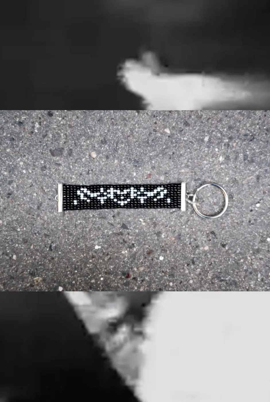 Black beaded keyring with white ACAB lettering
