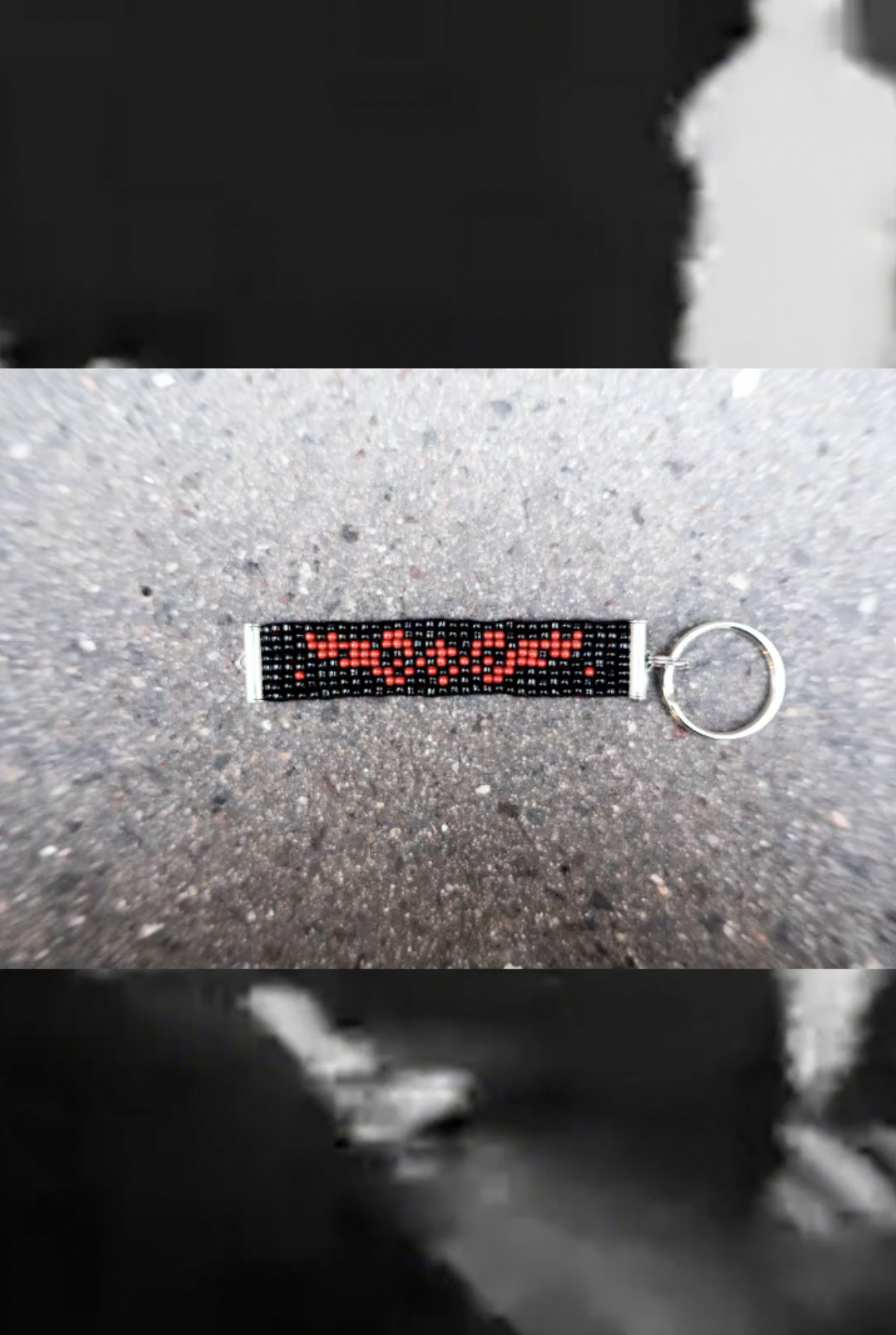 Black beaded keyring with a red chain-link motif