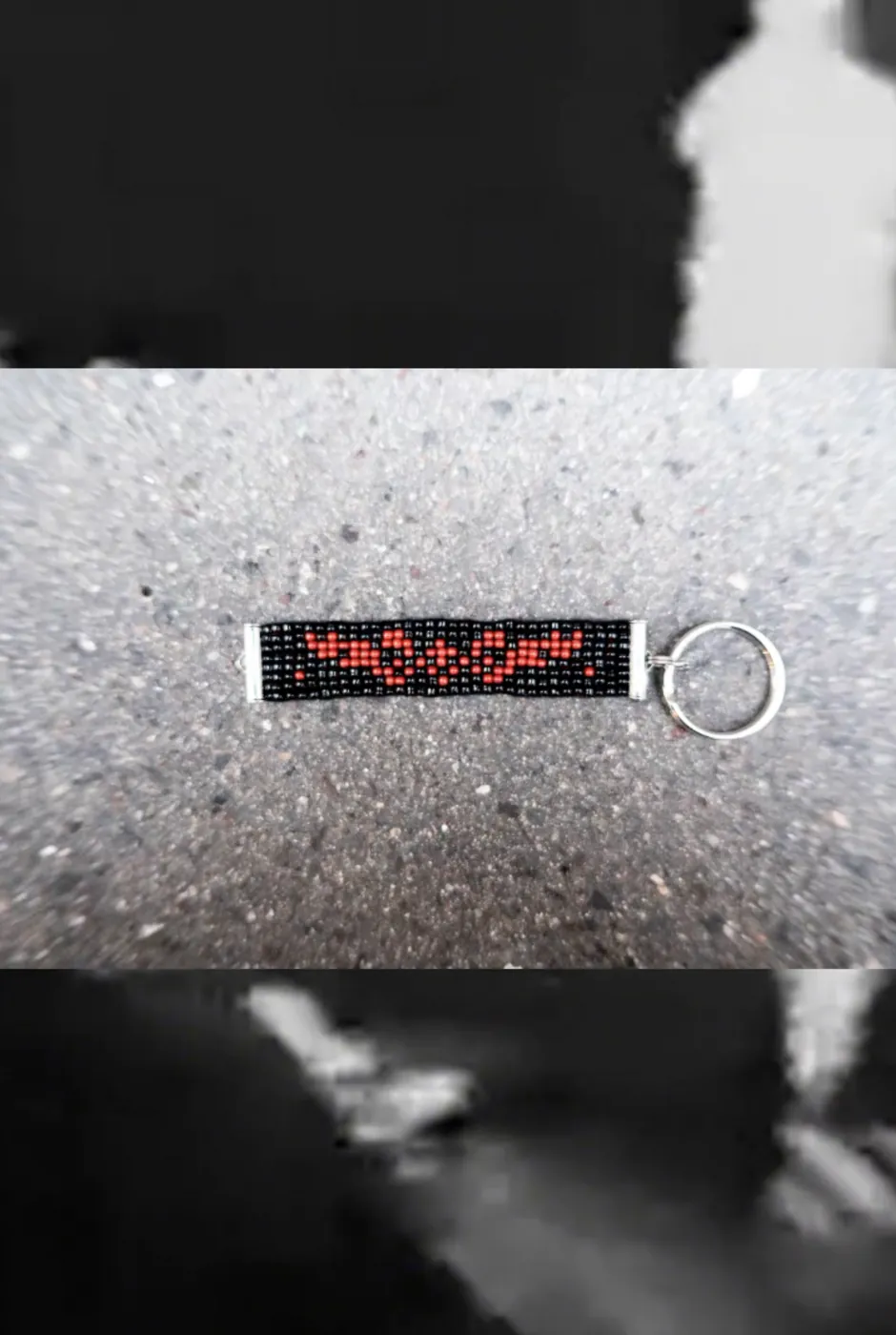 Black beaded keyring with a red chain-link motif