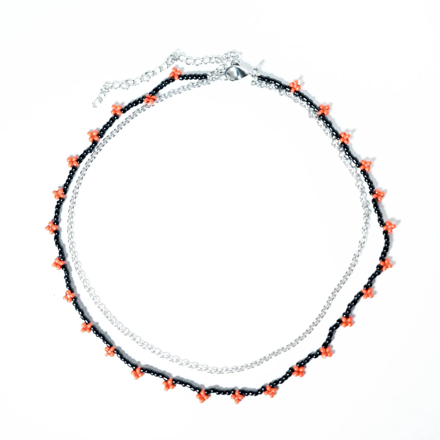 Black beaded necklace with small red flower details and silver chain