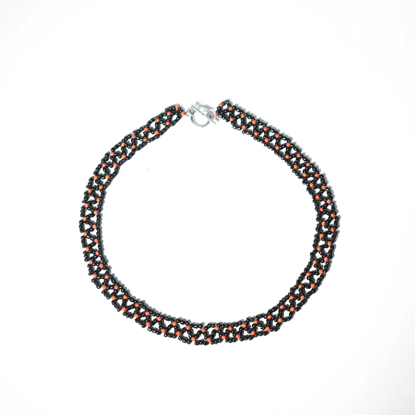 Wide woven black beaded necklace with red bead details